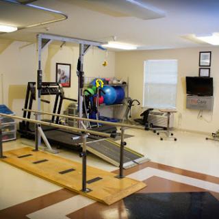 A rehabilitation gym equipped with various exercise machines and tools for physical therapy.