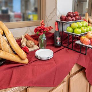 A beautifully arranged table featuring an assortment of bread and fresh fruits, perfect for a gathering.