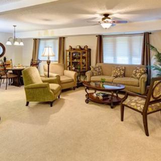 A spacious living room with comfortable seating and a dining area.