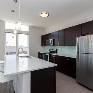 A modern kitchen with sleek cabinetry and stainless steel appliances.