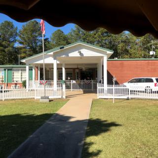 A well-designed building featuring a welcoming front entrance and an American flag.