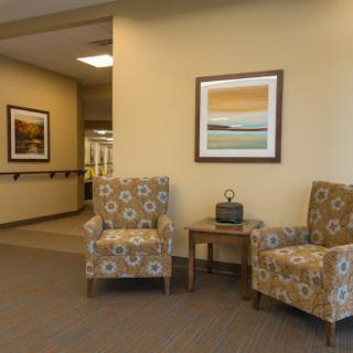 A cozy waiting area featuring patterned chairs and contemporary artwork.