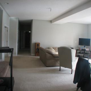 A cozy living room with a couch and television.