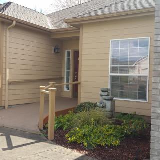 A welcoming entrance to a modern house with well-maintained landscaping.
