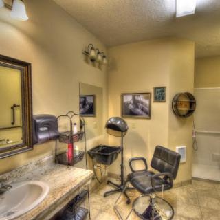 A cozy and well-equipped salon space featuring styling chairs and mirrors.