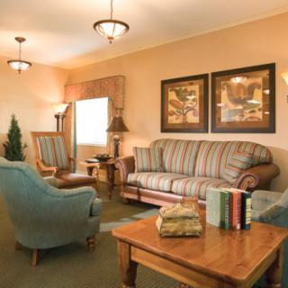 A cozy living room with comfortable seating and warm lighting.