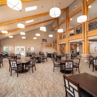 A spacious and modern dining area with elegant furniture and ambient lighting.