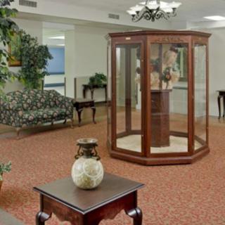 A hotel lobby featuring a display case and comfortable seating area.