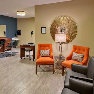 A stylish waiting room featuring modern furniture and decor.