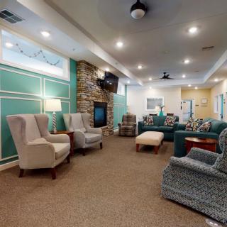 A cozy living room with comfortable seating and a fireplace.