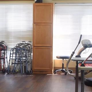 A room with exercise equipment and walkers, likely used for physical therapy.