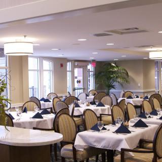 An elegant restaurant dining area with neatly arranged tables and chairs.
