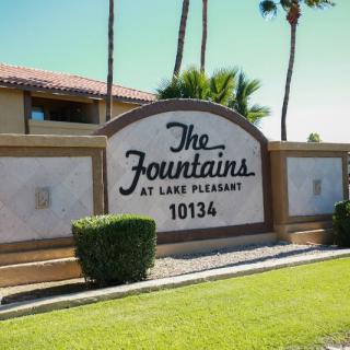 Entrance sign for The Fountains at Lake Pleasant apartment complex.