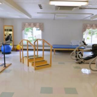 A rehabilitation room equipped with exercise machines and therapy tools.