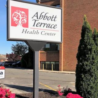 Signage for Abbott Terrace Health Center outside a building.