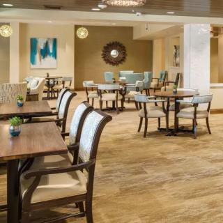 A modern dining area with neatly arranged tables and chairs, featuring stylish interior decor.