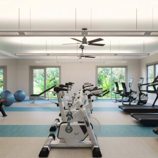 A modern gym with stationary bikes, treadmills, and exercise equipment.