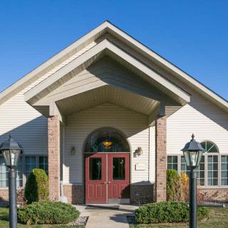 A front view of a house with a prominent entrance and well-maintained landscaping.