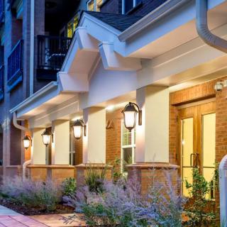 A modern residential building exterior illuminated at night.