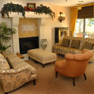 A cozy living room with elegant furniture and a warm fireplace.