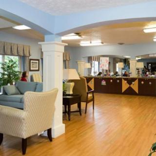 A cozy and well-decorated lounge area with sofas, chairs, and wooden flooring.