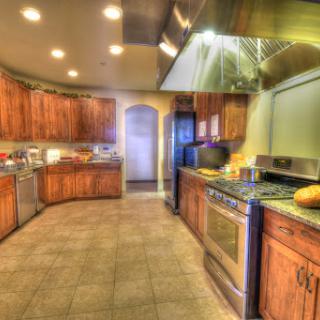 A spacious and modern kitchen featuring wooden cabinets and stainless steel appliances.