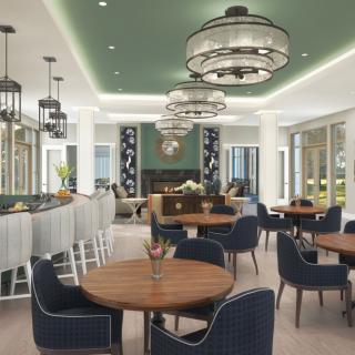 A modern restaurant interior featuring elegant chandeliers and a stylish seating area.