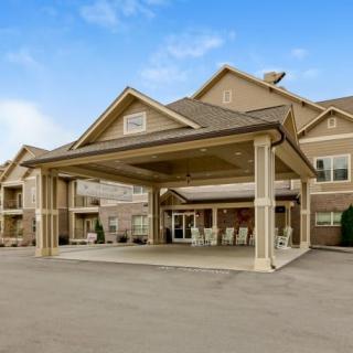 A commercial building with a covered entrance and clear blue sky.