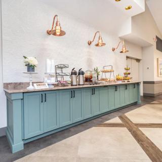 A modern buffet setup with stylish lighting and a sleek countertop.