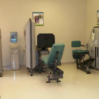A quiet gym space featuring various exercise machines and equipment.