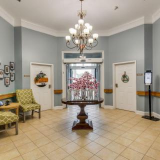 A well-decorated lobby with a chandelier and seating area.