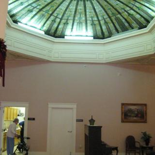 A spacious lobby with an elegant dome ceiling and comfortable seating.