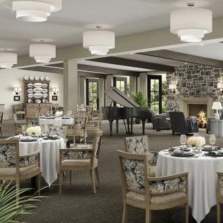 An elegant dining room interior with neatly arranged tables and a cozy fireplace.