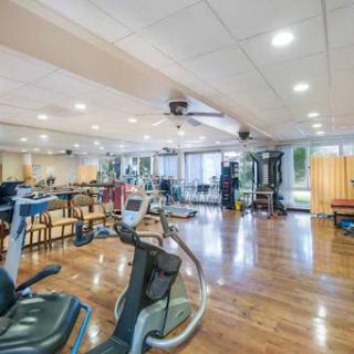 A well-equipped gym featuring various exercise machines and spacious workout areas.