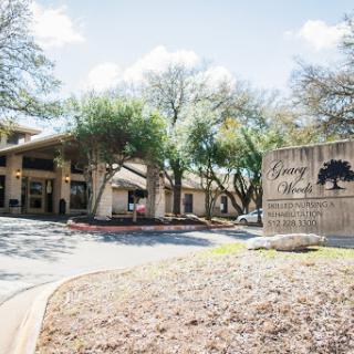 Entrance of a facility surrounded by greenery.