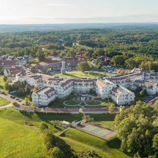 A breathtaking aerial view of a sprawling resort surrounded by lush greenery.