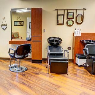 A well-organized hair salon interior with chairs, mirrors, and styling stations.