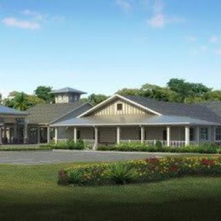 A spacious residential building with a well-maintained garden and clear blue sky.