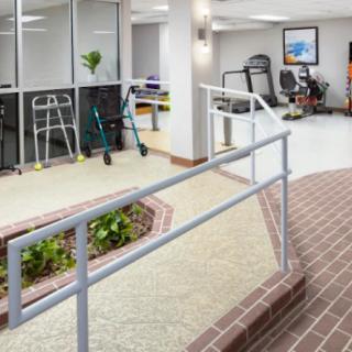 A healthcare facility featuring a wheelchair ramp and various rehabilitation equipment.