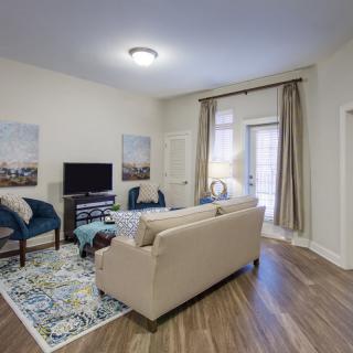 A well-decorated living room with modern furniture and decor.