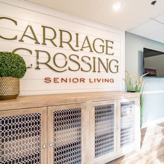 Interior view of Carriage Crossing Senior Living with decorative signage.