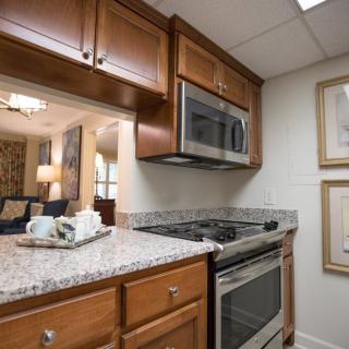 A modern kitchen with wood cabinets and stainless steel appliances.