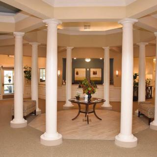 A spacious lobby featuring elegant columns and comfortable seating.