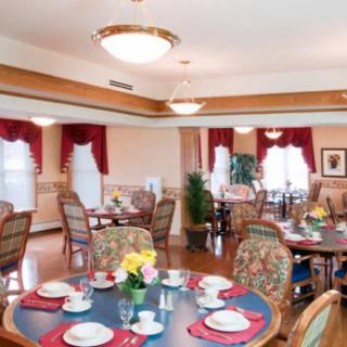 A well-decorated dining room with elegantly set tables and comfortable seating.