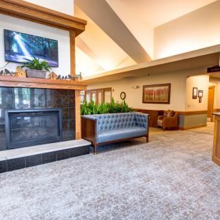 A modern and spacious lobby with a fireplace and contemporary seating.