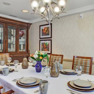 A well-appointed dining room with an elegant table setting and decorative accents.