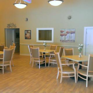 A spacious dining area with neatly arranged tables and chairs.