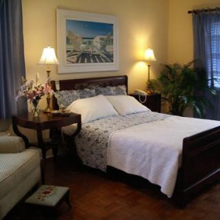 A cozy and inviting bedroom featuring a comfortable bed, elegant furnishings, and warm lighting.