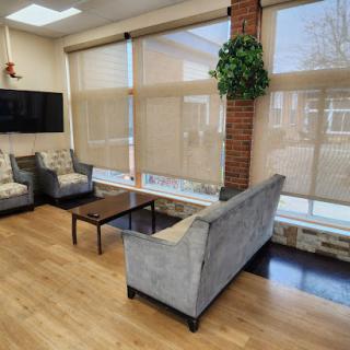 A cozy and modern living area featuring a comfortable sofa, stylish chairs, and plenty of natural light.
