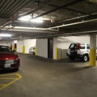 Cars parked inside a well-lit parking garage.